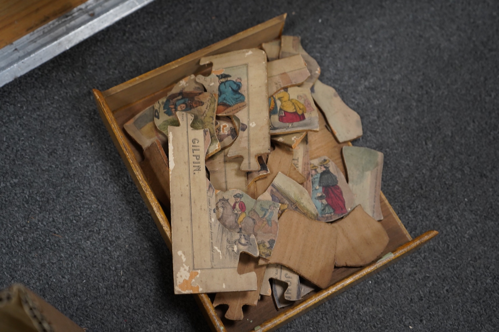 A collection of 19th century toys including; an early Jaques Ping Pong or Gossima set in an illustrated wooden case, a Crandall’s John Gilpin wooden horse with folded linen backed poster, ‘The Adventures of John Gilpin’